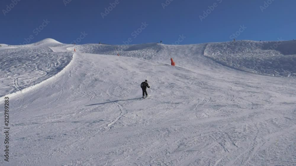 Skier Skiing Down The Slope, Turning Right And Left Fast, Brakes With Spray Snow Skier Skiing Down The Slope, Turning Right And Left Fast, Brakes With Spray Snow