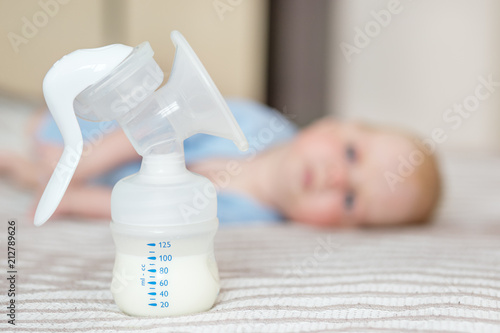 Breast pump with milk. The concept of childhood, motherhood, life style, upbringing. photo