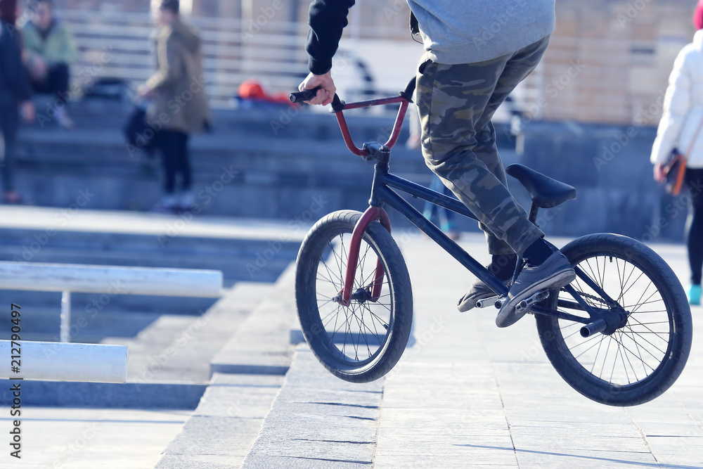 Naklejka premium street cyclist jumps on Bicycle.