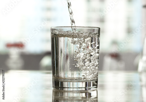 Water is poured into a glass.