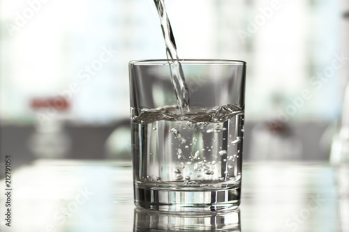 Water is poured into a glass.
