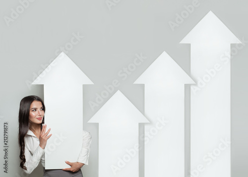 Business Manager with Rising Arrow Columns, Representing Business Growth. Business Success and Shares Up Concept photo