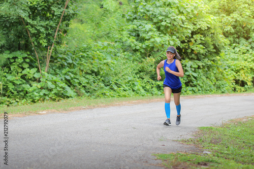 Wallpaper Mural Asian woman were jogging on the road In the forest.wide angle copy space image. Torontodigital.ca