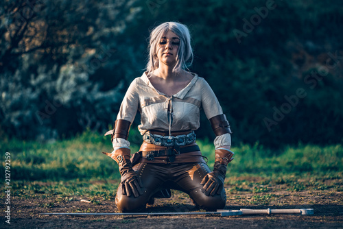 Fantasy cosplay beautiful Witcher girl with sword