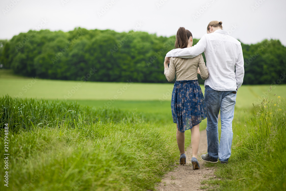 Couple holding hands at the green walk Couple holding hands at the green walk