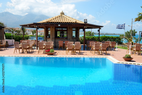 The swimming pool near bar and Greek flag, Peloponnes, Greece © slava296