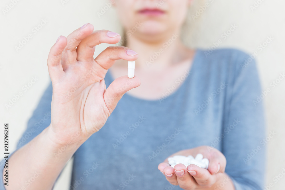 White tablets in female hands. Selective focus. White tablets in female hands. Selective focus.