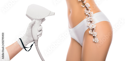 Concept of laser hair removal and cosmetology. Cosmetologist uses a laser, hair removal on the abdomen, hips, bikini zone. Laser hair removal part of body isolated on white