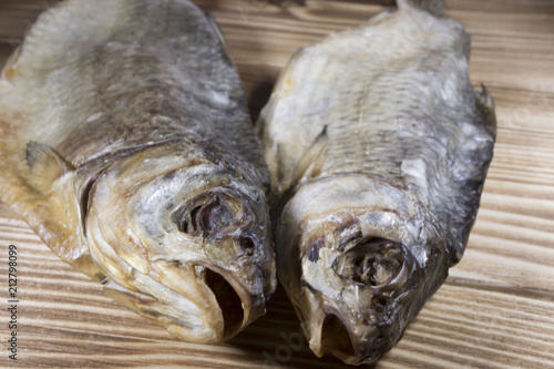 Dried fish on the table. Salty dry river fish on a dark wooden background.top view photo