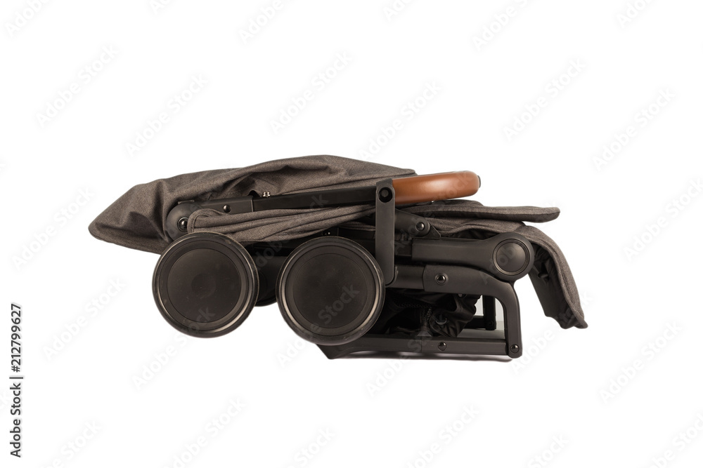 Baby carriage in folded condition for transportation on a trip. Baby carriage in folded condition for transportation on a trip.