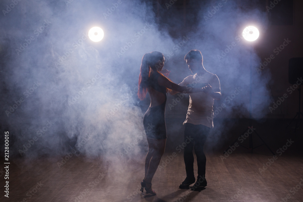 Young couple dancing latin dance Bachata, merengue, salsa. Two elegance pose in dance class