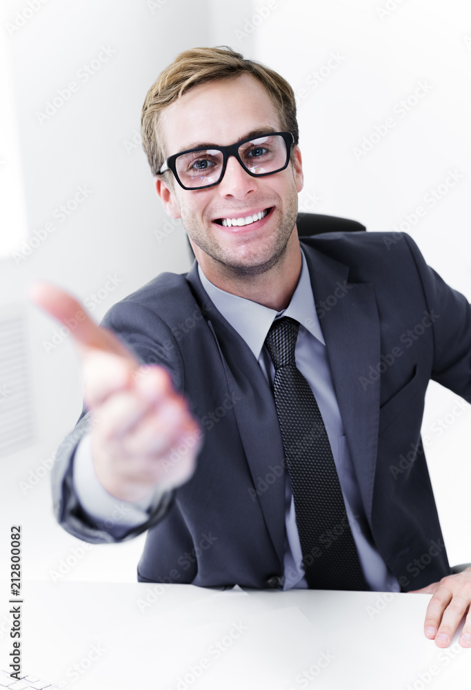 Smiling businessman giving hand for handshake Smiling businessman giving hand for handshake