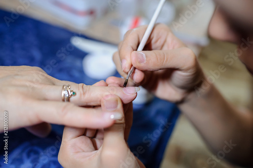 Manicurist master at nail work
