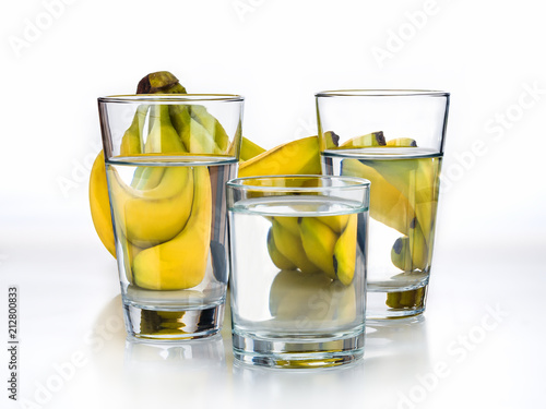 Fresh Bananas and glass of water on the white background