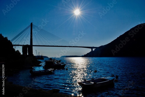 Fototapeta Naklejka Na Ścianę i Meble -  Sunset in The Dubrovnik Bridge, Croatia. Reflections on The Adriatic Sea. 