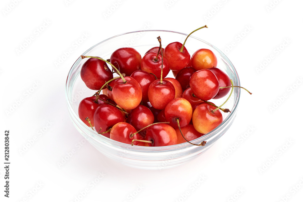 Sweet yellow cherry in glass pot, isolated on white background. Close-up. Sweet yellow cherry in glass pot, isolated on white background. Close-up.