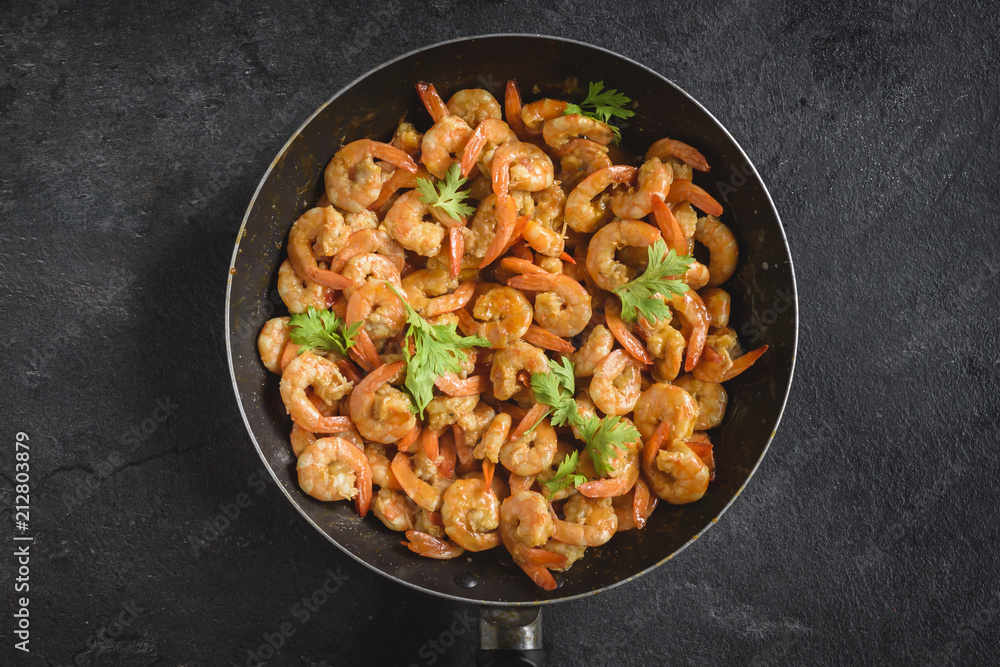 Fried shrimps in the pan on dark background Fried shrimps in the pan on dark background