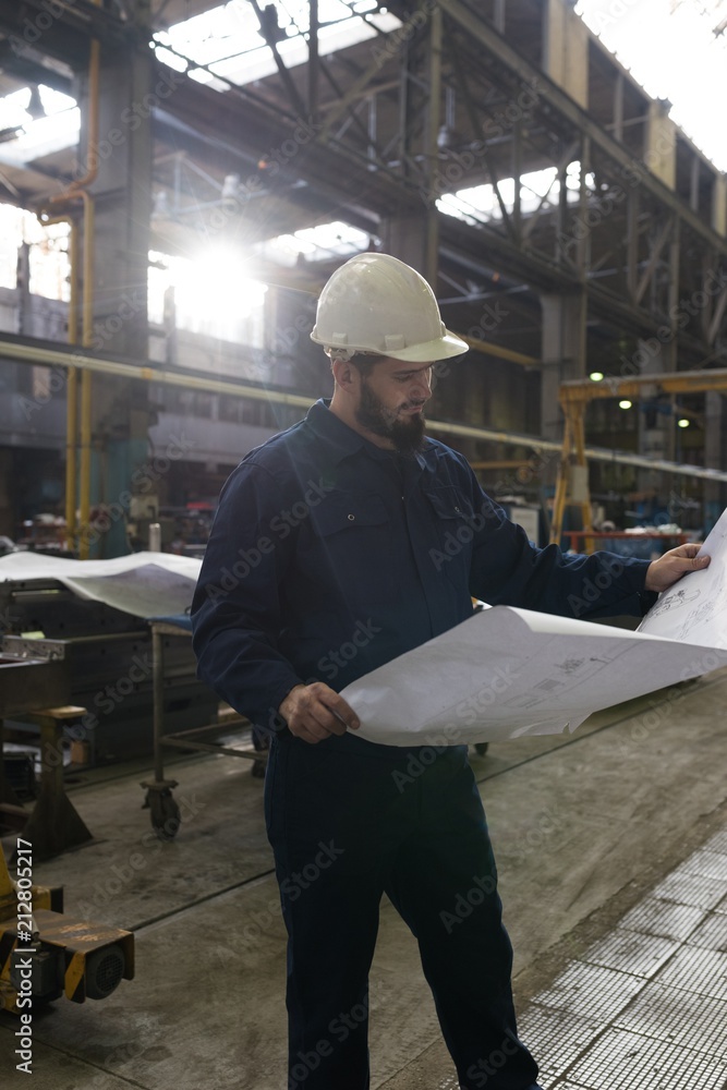 Technician looking at blue print Technician looking at blue print