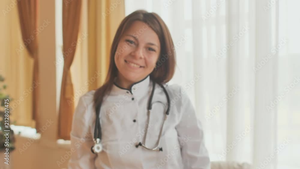 Portrait of a young female doctor in a good mood who shows thumbs up. Portrait of a young female doctor in a good mood who shows thumbs up.