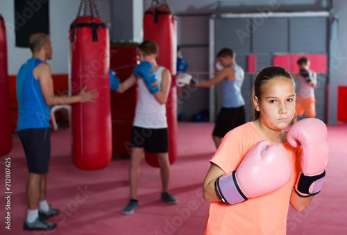 Portrait of ordinary girl boxer in boxing hall