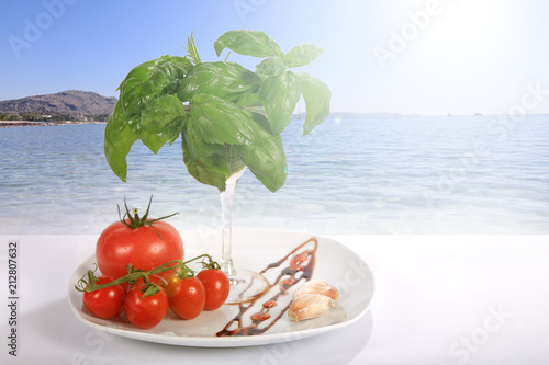 Pomidory i bazylia na tarasie nad morzem Śrudziemnym.