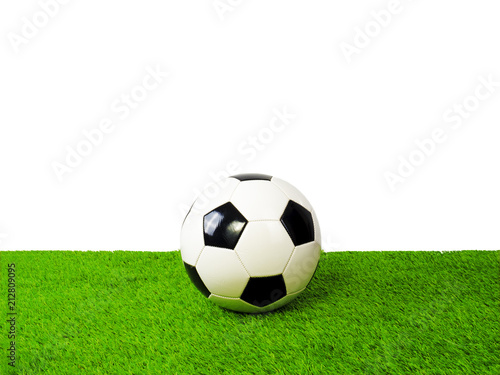 Soccer football ball on green grass field isolated on white background with clipping path. © kravik93