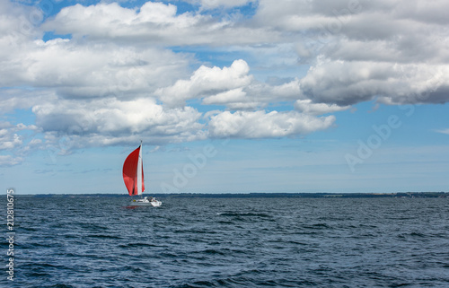 Sailing boat in the sea. Red sails