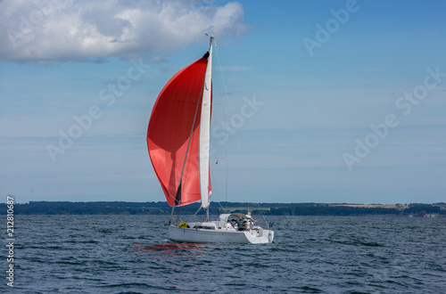 Sailing boat in the sea. Red sails