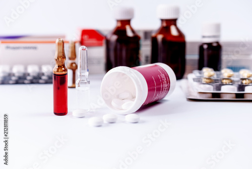 Ampoules and medical preparations on white table