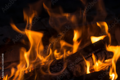 Large burning bonfire with soft glowing flame and sparkles flying all around photo