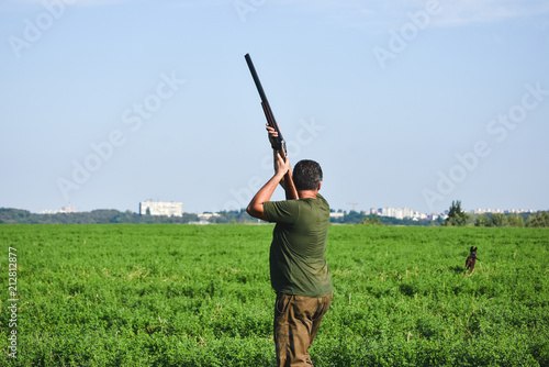 Hunter shoot with double barrel gun. photo
