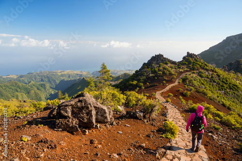 Young woman hiking on path to Pico Ruivo, highest peak of Madeira island, Portugal photo