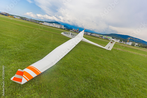 Image glider on the green lawn of the airfield. 