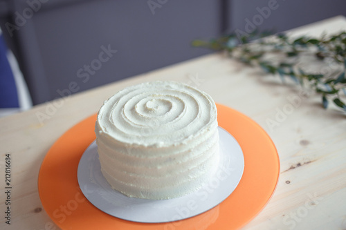 White sponge cake on wooden bright table