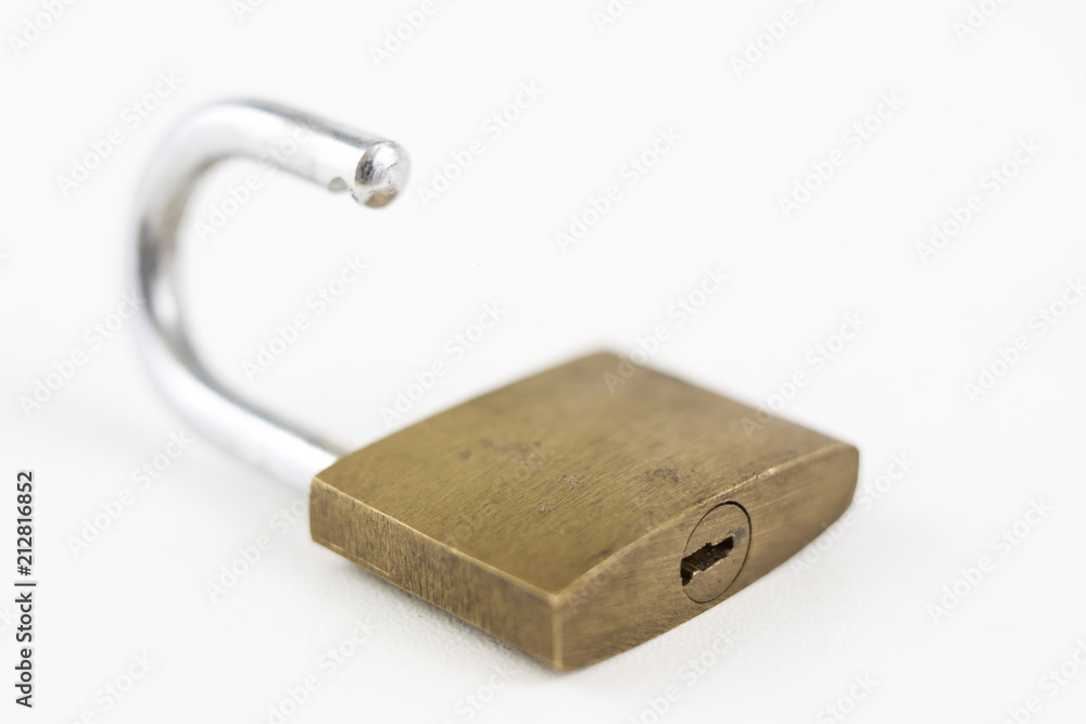 Brass padlock on a white table. Accessories for locking and securing against burglary. Brass padlock on a white table. Accessories for locking and securing against burglary.