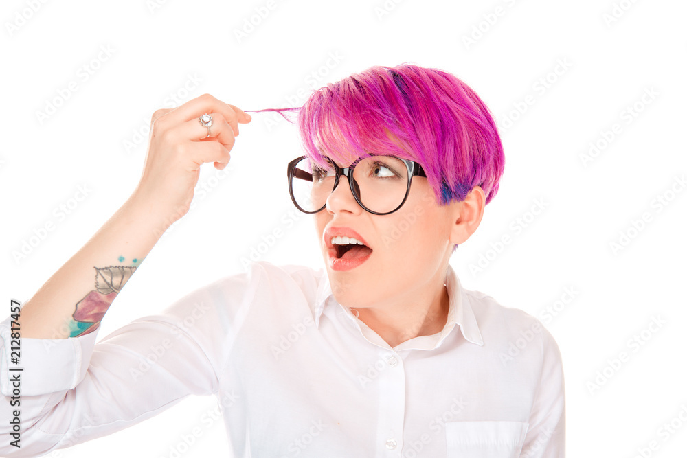 annoyed woman looking worried at her pink magenta color hair