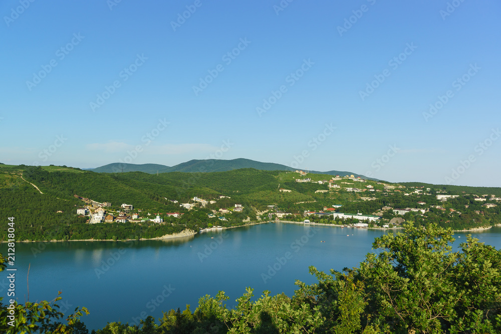 Top view of the picturesque lake Abrau against the slopes of the Caucasus mountains. Sunny summer day