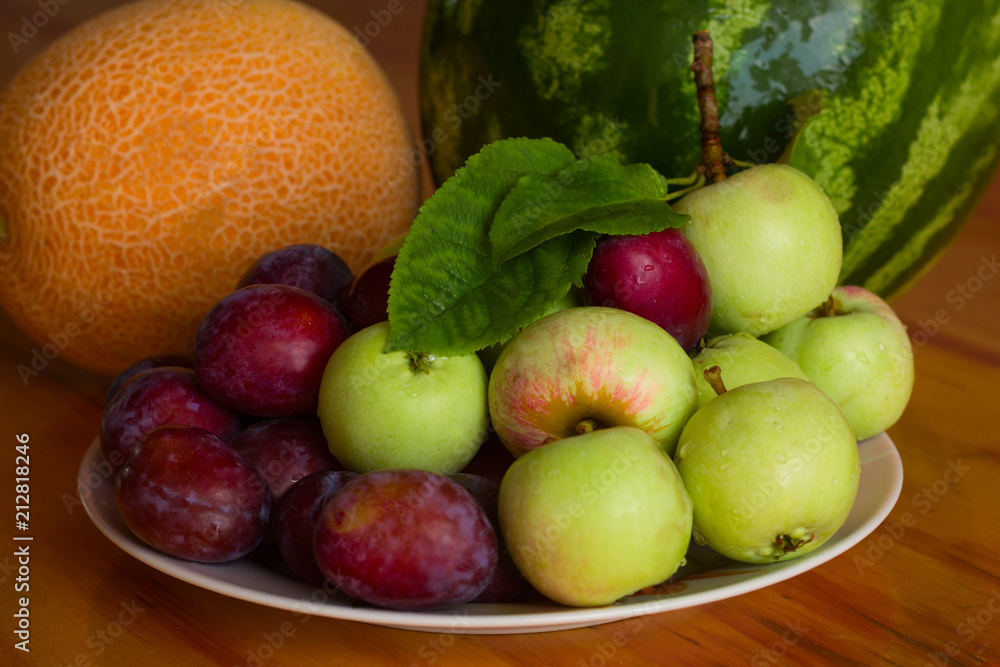 fresh sweet fruits on a plate on a wooden table fresh sweet fruits on a plate on a wooden table