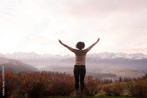 Woman standing with arms outstretched