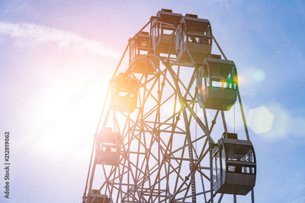 Ferris wheel on cloudy sky background Ferris wheel on cloudy sky background