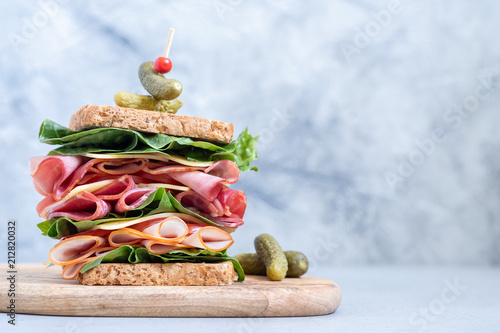 Fotografie Big sandwich with ham, deli meat and vegetables