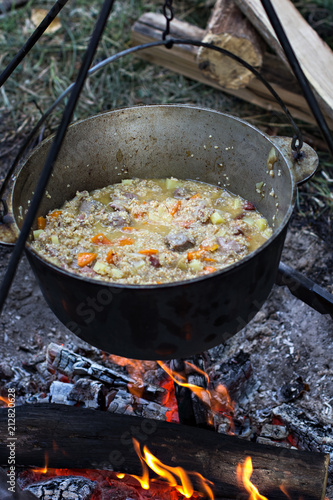 A pot of meat over a fire. Hike, summer vacation, outdoor recreation, outdoor food.