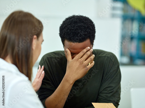 Sad African-American student with friend