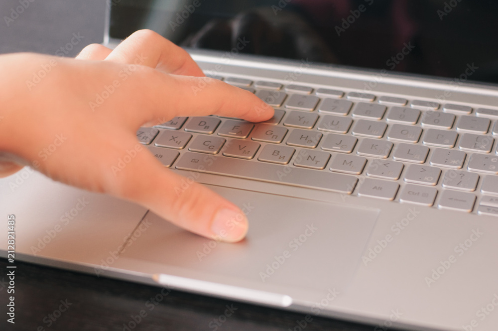 One hand typing on the laptop keyboard One hand typing on the laptop keyboard
