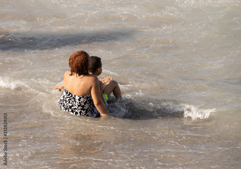 Fototapeta premium unknown mother spending a special moment with her son at the beach