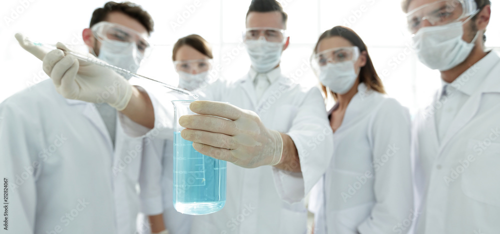 closeup of a group of medical workers working with liquids closeup of a group of medical workers working with liquids