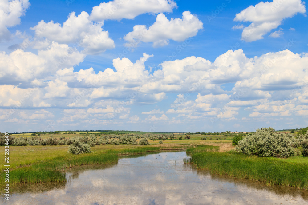 Summer landscape with small river and blue cloudy sky Summer landscape with small river and blue cloudy sky