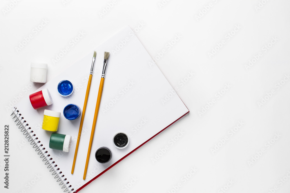 Drawing notebook, gouache paints, on white surface Drawing notebook, gouache paints, on white surface