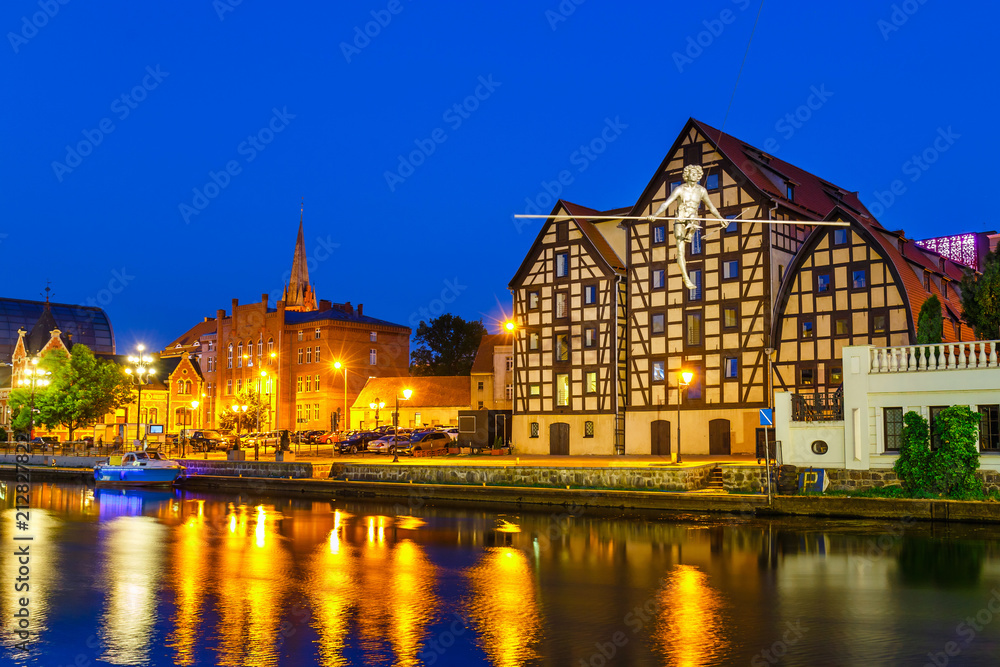 The waterfront on the river Brda with famous granaries at night in Bydgoszcz, Poland