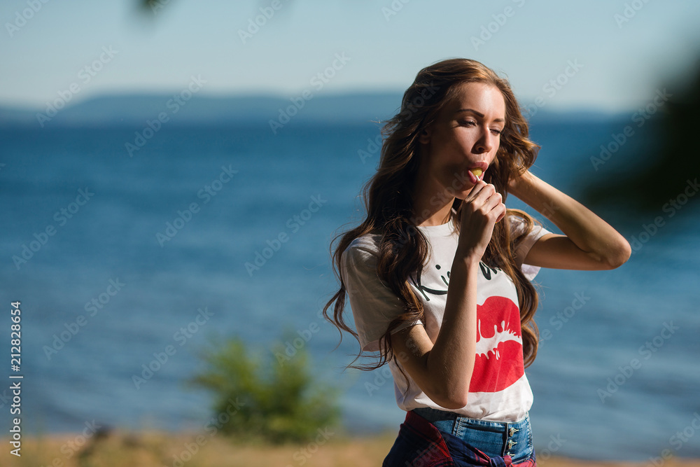 Beautiful girl sucks Lollipop in summer outdoors Beautiful girl sucks Lollipop in summer outdoors